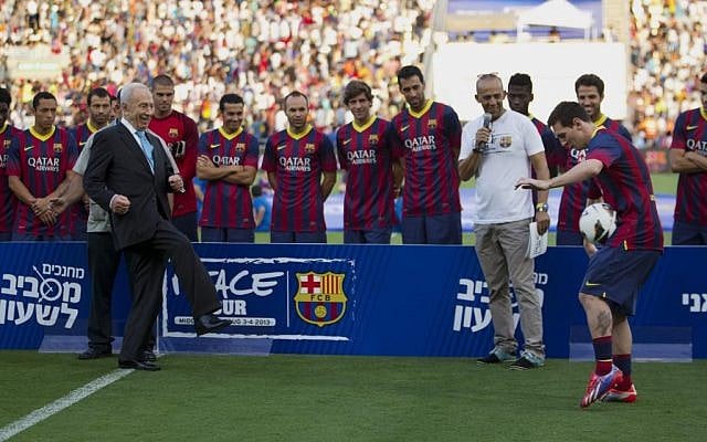 President Shimon Peres kicks the ball to FC Barcelona's Argentinian striker Lionel Messi during a football clinic session in Broomfield stadium in Tel Aviv, Israel, Sunday, Aug. 4, 2013. (photo credit: AP Photo/Ariel Schalit)