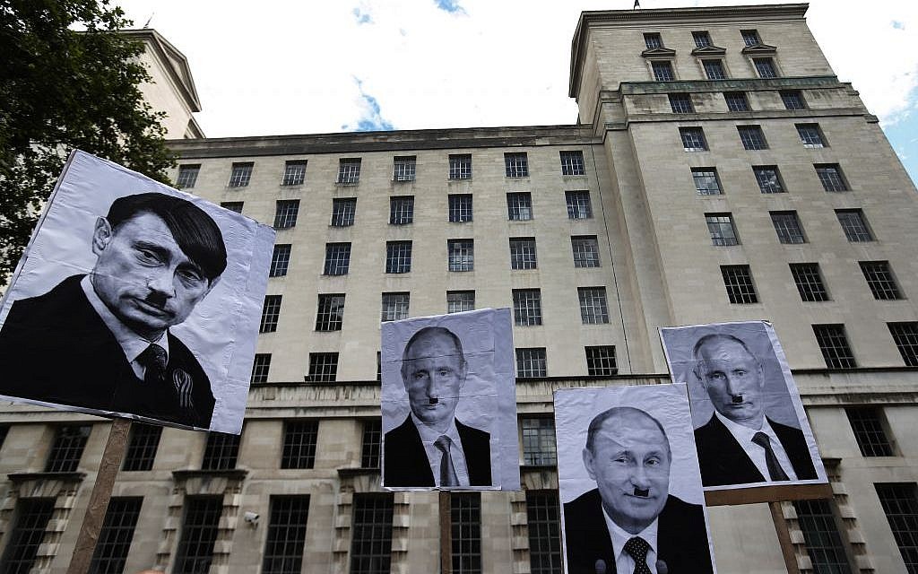Protest signs displayed in London over the weekend liken Russian leader Vladimir Putin to Adolf Hitler. (AP Photo/Lefteris Pitarakis) Protest signs displayed in London over the weekend liken Russian leader Vladimir Putin to Adolf Hitler. (AP Photo/Lefteris Pitarakis)
