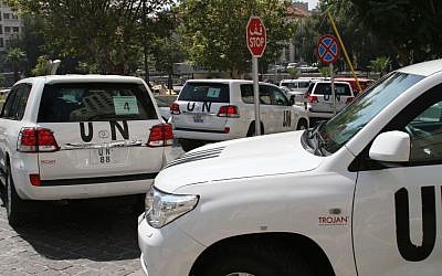 A UN team investigating an alleged chemical attack that killed hundreds last week in a Damascus suburb, leaves their hotel in a convoy, in Damascus, Syria (photo credit: AP)