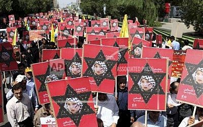 Iranians attend an annual pro-Palestinian rally marking Al-Quds (Jerusalem) Day in Tehran, Iran, Friday, Aug. 2, 2013. Ahead of his inauguration, Iran’s new president, Hasan Rouhani, on Friday called Israel an “old wound” that should be removed, while thousands of Iranians marched in support of Muslim claims to the holy city of Jerusalem. (Photo credit: AP/Ebrahim Noroozi) Iranians attend an annual pro-Palestinian rally marking Al-Quds (Jerusalem) Day in Tehran, Iran, Friday, Aug. 2, 2013. Ahead of his inauguration, Iran’s new president, Hasan Rouhani, on Friday called Israel an “old wound” that should be removed, while thousands of Iranians marched in support of Muslim claims to the holy city of Jerusalem. (Photo credit: AP/Ebrahim Noroozi)