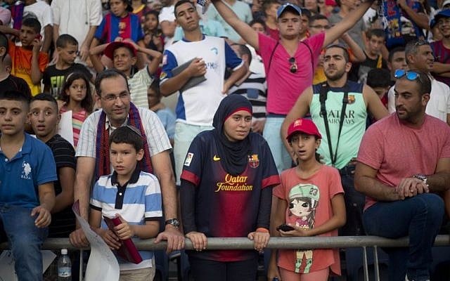 Israeli Jews and Arabs watch, together, as FC Barcelona plays in Bloomfield Stadium in Tel Aviv, Israel, Sunday, August 4, 2013. (photo credit: AP Photo/Ariel Schalit)