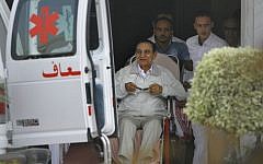 Former Egyptian President Hosni Mubarak, 85, is escorted by medical and security personnel into an ambulance to be taken by helicopter ambulance from to court, Cairo, Egypt, Sunday, Aug. 25, 2013. (photo credit:AP/Amr Nabil)