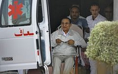 Former Egyptian president Hosni Mubarak, 85, is escorted by medical and security personnel into an ambulance en route from Maadi Military Hospital to the Cairo Police Academy-turned-court, Cairo, Egypt, Sunday, Aug. 25, 2013 (photo credit: AP/Amr Nabil)