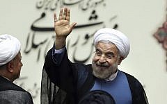 Iranian President Hassan Rouhani waves after his swearing-in ceremony at the parliament, in Tehran, August 4, 2013. (photo credit: AP/Ebrahim Noroozi)
