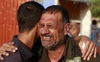 Relatives grieve for Mohammed Ali, 18, who was killed on Friday when a suicide bomber attacked a park in Baghdad, Iraq, on Saturday, August 24, 2013. (photo credit: AP/Hadi Mizban) Relatives grieve for Mohammed Ali, 18, who was killed when a suicide bomber attacked a park in Baghdad, Iraq, on Saturday, August 24, 2013. (photo credit: AP/Hadi Mizban)