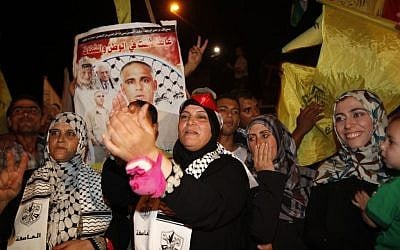 Relatives of Atef Sha’ath, one of the freed Palestinian prisoners, celebrate while waiting for his release at the checkpoint at the entrance of Beit Hanoun in Gaza, Tuesday, Aug. 13, 2013. (photo credit: AP Photo/Adel Hana) Relatives of Atef Sha’ath, one of the freed Palestinian prisoners, celebrate while waiting for his release at the checkpoint at the entrance of Beit Hanoun in Gaza, Tuesday, Aug. 13, 2013. (photo credit: AP Photo/Adel Hana)