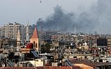 Columns of smoke rising from heavy shelling in the Jobar neighborhood in west Damascus, Syria. (photo credit: AP/Hassan Ammar)
