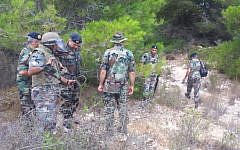 A picture published by Shi'ite terror group Hezbollah's Al-Manar TV station shows Lebanese soldiers at the scene of an explosion which left four Israeli soldiers injured, Wednesday, August 7, 2013 (photo credit: Al-Manar News)