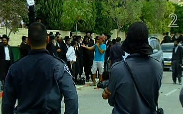 Police officers face off with ultra-Orthodox protesters in Beit Shemesh on Monday, Aug 12 (image capture: Channel 2) Police officers face off with ultra-Orthodox protesters in Beit Shemesh on Monday, Aug 12 (image capture: Channel 2)