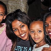 Maggie Meganenke Mengisto, second from right, and Zahava Mero, right, visit their young cousins, Damaka's daughters (photo credit: Michal Shmulovich/ToI)