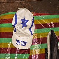 A white hate adorned with the Jewish star of David and the word "Israel" hangs high on Damaka's wall (photo credit: Michal Shmulovich/ToI)