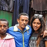 After a few moments of awkward embraces and a short exchange, Maggie Mengisto and her half-brother, left, pose for a photo with Maggie's uncle, Damaka Mengisto (photo credit: Michal Shmulovich/ToI)