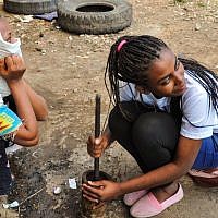 Amaya, a Samai participant, outside her aunt's house in Gondar, digs up memories of how her family used to make Ethiopian coffee, known as Buna, by freshly roasting and then mashing fresh coffee beans (photo credit: Michal Shmulovich/ToI)