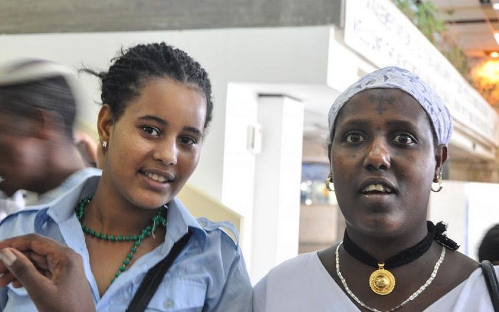 Moonmoone, left, and Sugaro wait at Ben Gurion Airport for relatives to arrive from Gondar, Ethiopia on Wednesday (photo credit: Michal Shmulovich/ToI)