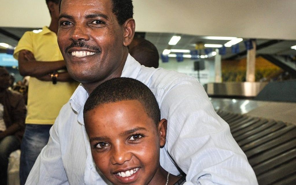 Solomon Mogose and his 14-year-old nephew, who just arrived from Gondar, at Ben Gurion airport Wednesday (photo credit: Michal Shmulovich/ToI)