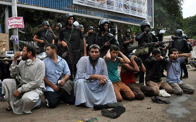 Egyptian security forces detain supporters of ousted Islamist President Mohammed Morsi on Wednesday in Cairo. (photo credit: AP/Hussein Tallal) Egyptian security forces detain supporters of ousted Islamist President Mohammed Morsi on Wednesday in Cairo. (photo credit: AP/Hussein Tallal)