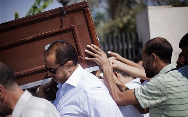 Friends and relatives of Ammar Badie, 38, killed Friday by Egyptian security forces during clashes in Ramses Square, and also son of Muslim Brotherhood's spiritual leader Mohammed Badie, carry his coffin during his funeral in al-Hamed mosque in Cairo's Katameya district, Egypt, Sunday, Aug. 18, 2013 (photo credit: AP/Manu Brabo) Friends and relatives of Ammar Badie, 38, killed Friday by Egyptian security forces during clashes in Ramses Square, and also son of Muslim Brotherhood's spiritual leader Mohammed Badie, carry his coffin during his funeral in al-Hamed mosque in Cairo's Katameya district, Egypt, Sunday, Aug. 18, 2013 (photo credit: AP/Manu Brabo)