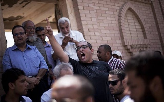 A friend of Ammar Badie, 38, killed Friday by Egyptian security forces during clashes in Ramses Square, and also son of Muslim Brotherhood's spiritual leader Mohammed Badie, shouts, "Allah is the greatest," while attending his burial in Cairo's Katameya district, Egypt, Sunday, Aug. 18, 2013 (photo credit: AP/Manu Brabo) A friend of Ammar Badie, 38, killed Friday by Egyptian security forces during clashes in Ramses Square, and also son of Muslim Brotherhood's spiritual leader Mohammed Badie, shouts, "Allah is the greatest," while attending his burial in Cairo's Katameya district, Egypt, Sunday, Aug. 18, 2013 (photo credit: AP/Manu Brabo)