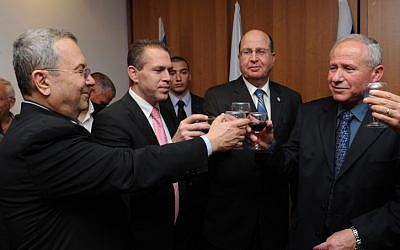 Gilad Erdan, in a pink tie, upon taking office. Far right is the outgoing minister, Avi Dichter, along with Defense Minister Moshe Ya'alon, blue tie, and Ehud Barak (photo credit: Defense Ministry/Flash 90)