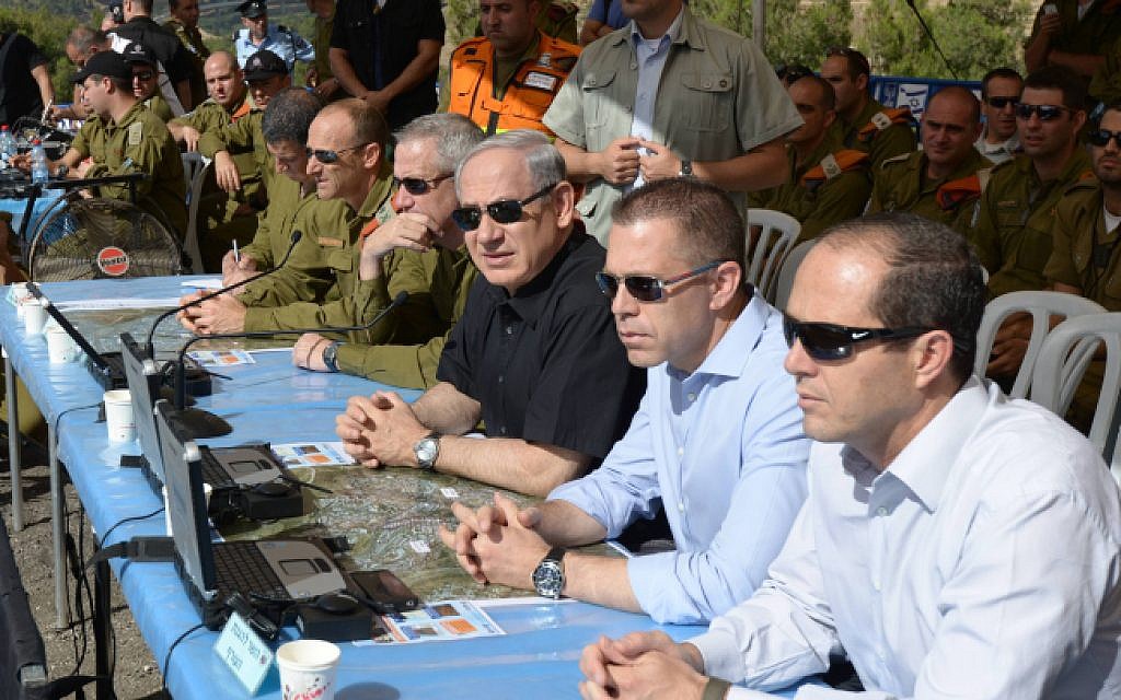 File: Prime Minister Benjamin Netanyahu, in the middle in black, flanked by then-home front defense Minister Gilad Erdan, in blue, and then-IDF Chief of Staff Lt. Gen. Benny Gantz and Maj. Gen. Eyal Eisenberg in May 2013. (Amos Ben Gershom/GPO/Flash90) File: Prime Minister Benjamin Netanyahu, in the middle in black, flanked by then-home front defense Minister Gilad Erdan, in blue, and then-IDF Chief of Staff Lt. Gen. Benny Gantz and Maj. Gen. Eyal Eisenberg in May 2013. (Amos Ben Gershom/GPO/Flash90)
