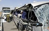 Police and rescue personnel seen at the site of an accident that left four people dead and dozens injured after a bus and a garbage truck collided on Route 6, Sunday, August 4, 2013 (photo credit: David Buimovitch/Flash90)