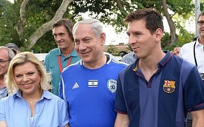 Prime Minister Benjamin Netanyahu and his wife, Sara, walk alongside FC Barcelona superstar Lionel Messi, Sunday, August 4, 2013 (photo credit: Avi Ohayon/GPO/Flash90)