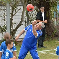 Prime Minister Benjamin Netanyahu playing soccer with young cancer sufferers, prior to FC Barcelona's practice in Jaffa's Bloomfield Stadium, near Tel Aviv on August 04, 2013.  (Photo credit: Avi Ohayon/GPO/FLASH90)