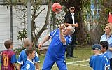 Prime Minister Benjamin Netanyahu plays with a soccer ball as he meets young cancer patients and the FC Barcelona soccer team, prior to FC Barcelona's open practice in Jaffa's Bloomfield Stadium, near Tel Aviv, Sunday, August 4, 2013 (photo credit: Avi Ohayon/GPO/Flash90)