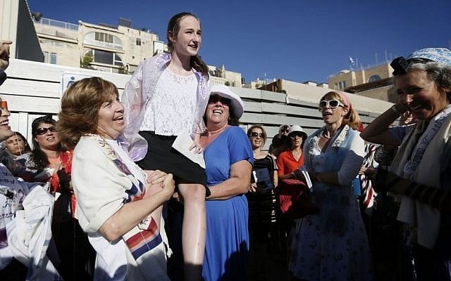 Hoffman, left, holds up a young girl during her bat mitzva at Western Wall on August 7, 2013. (photo credit: Miriam Alster/Flash90)