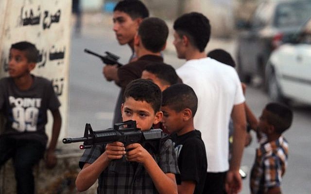 An illustrative photo of Palestinian boys playing with toy guns (photo credit: Issam Rimawi/Flash90)s An illustrative photo of Palestinian boys playing with toy guns (photo credit: Issam Rimawi/Flash90)s