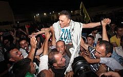 A released Palestinian prisoner is welcomed as he arrives at the Palestinian Authority headquarters in the West Bank city of Ramallah, August 2013 (photo credit: Issam Rimawi/Flash90)