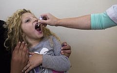 A child being vaccinated in Jerusalem Monday. (photo credit: Yonatan Sindel/Flash90)