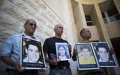 Relatives of Israelis killed in terror attacks holding signs as they demonstrate outside the Supreme Court in Jerusalem on August 11, 2013. (photo credit: Yonatan Sindel/Flash90)