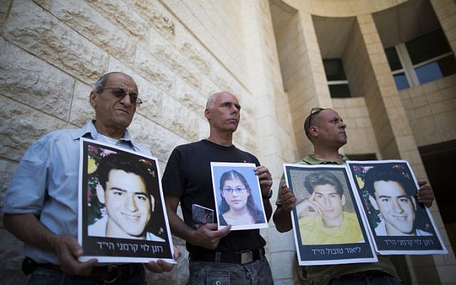 Relatives of Israelis killed in terror attacks holding signs as they demonstrate outside the Supreme Court in Jerusalem on August 11, 2013. (photo credit: Yonatan Sindel/Flash90)