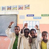 Students hold up their dreidels and sing the Hannukah songs they were taught at school (photo credit: Michal Shmulovich/ToI)