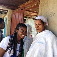 A participant in the Samai trip, which brought Ethiopian-Israeli teens to their native homeland last December, talks to her relative at the Gondar synagogue (photo credit: Michal Shmulovich/ToI)
