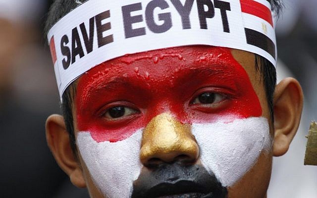In Jakarta, Indonesia on Friday, an Indonesian Muslim man with his face painted in the colors of the Egyptian flag takes part in a rally calling for an end to the violence used against Egypt's supporters of ousted president Mohammed Morsi in Egypt. (photo credit: AAP Photo/Achmad Ibrahim) In Jakarta, Indonesia on Friday, an Indonesian Muslim man with his face painted in the colors of the Egyptian flag takes part in a rally calling for an end to the violence used against Egypt's supporters of ousted president Mohammed Morsi in Egypt. (photo credit: AAP Photo/Achmad Ibrahim)