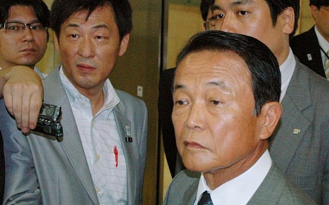 Japanese Finance Minister Taro Aso is surrounded by reporters at the ministry in Tokyo Thursday, August 1, 2013. (photo credit: AP/Kyodo News) Japanese Finance Minister Taro Aso is surrounded by reporters at the ministry in Tokyo Thursday, August 1, 2013. (photo credit: AP/Kyodo News)