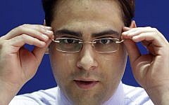 Rafat Awad, a 23 year old Palestinian pharmacist, adjusts his glasses in while posing for a portrait at a shopping mall in Dubai, United Arab Emirates on Wednesday, July 31. (photo credit: AP Photo/Kamran Jebreili)