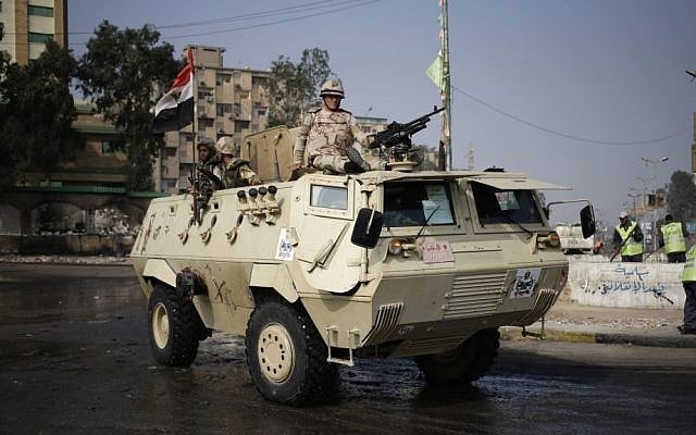 Egyptian Army soldiers stand guard outside the Rabaah al-Adawiya mosque, in the center of the largest protest camp of supporters of ousted president Mohammed Morsi, that was cleared by security forces, in the district of Nasr City, Cairo, Egypt, Friday, August 16, (photo credit: AP/Hassan Ammar) Egyptian Army soldiers stand guard outside the Rabaah al-Adawiya mosque, in the center of the largest protest camp of supporters of ousted president Mohammed Morsi, that was cleared by security forces, in the district of Nasr City, Cairo, Egypt, Friday, August 16, (photo credit: AP/Hassan Ammar)