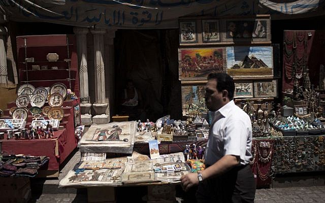An Egyptian man walks in front of a souvenir store in the Khan El-Khalili market, normally a popular tourist destination, in Cairo, Egypt, Wednesday, August 21, 2013. (photo credit: AP Photo/Manu Brabo)