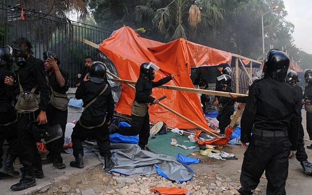 Egyptian security forces clear a sit-in camp set up by supporters of ousted Islamist President Mohammed Morsi near Cairo University in Cairo's Giza district, Egypt, on Wednesday, Aug. 14, 2013. (photo credit: AP Photo/Mohammed Asad)