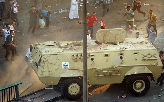 Supporters of ousted Islamist President Mohammed Morsi capture an Egyptian security forces vehicle at the Ministry of Finance in Cairo, Egypt, Wednesday, August 14, 2013. (photo credit: AP Photo/Mohsen Nabil) Supporters of ousted Islamist President Mohammed Morsi capture an Egyptian security forces vehicle at the Ministry of Finance in Cairo, Egypt, Wednesday, August 14, 2013. (photo credit: AP Photo/Mohsen Nabil)