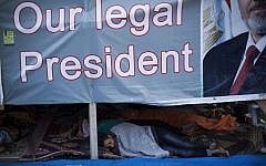 Supporters of Egypt's ousted President Mohammed Morsi sleep their tent at the sit-in at Rabaa Al-Adawiya mosque in Nasser City, Cairo, Egypt, Monday, Aug. 12 (photo credit: AP/Manu Brabo)