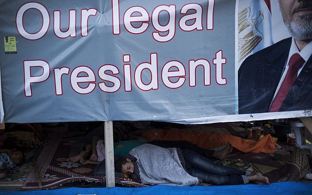 Supporters of Egypt's ousted President Mohammed Morsi sleep their tent at the sit-in at Rabaa Al-Adawiya mosque in Nasser City, Cairo, Egypt, Monday, Aug. 12 (photo credit: AP/Manu Brabo) Supporters of Egypt's ousted President Mohammed Morsi sleep their tent at the sit-in at Rabaa Al-Adawiya mosque in Nasser City, Cairo, Egypt, Monday, Aug. 12 (photo credit: AP/Manu Brabo)