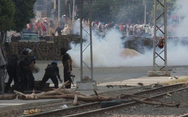 In this image made from video by AP video, Egyptian security forces throw tear gas towards supporters of ousted Islamist President Mohammed Morsi at a sit-in in Cairo, Egypt, Wednesday, Aug. 14, 2013. (AP video) In this image made from video by AP video, Egyptian security forces throw tear gas towards supporters of ousted Islamist President Mohammed Morsi at a sit-in in Cairo, Egypt, Wednesday, Aug. 14, 2013. (AP video)