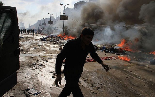 Egyptian security forces clear a sit-in by supporters of ousted Islamist President Mohammed Morsi in the eastern Nasr City district of Cairo, Egypt, Wednesday, Aug. 14, 2013. (Photo credit: AP/Ahmed Gomaa)
