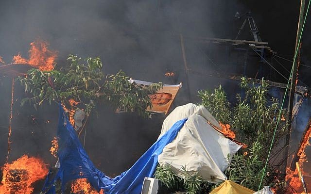 Fires burn as Egyptian security forces clear a sit-in by supporters of ousted Islamist President Mohammed Morsi in the eastern Nasr City district of Cairo, Egypt, Wednesday, Aug. 14, 2013. (Photo credit: AP/Ahmed Gomaa)