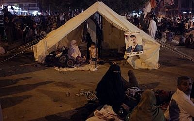 Supporters of Egypt's ousted President Mohammed Morsi sit in a tent they set up during a protest near Cairo airport in Cairo, Egypt, Friday, Aug. 2 (photo credit: AP/Khalil Hamra)