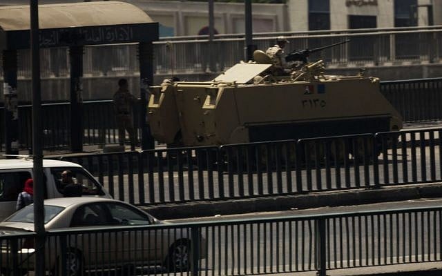 An Egyptian army armored vehicle is seen on a bridge over the Nile river at Zamalek District in Cairo on Saturday. (photo credit: AP/Manu Brabo) An Egyptian army armored vehicle is seen on a bridge over the Nile river at Zamalek District in Cairo on Saturday. (photo credit: AP/Manu Brabo)